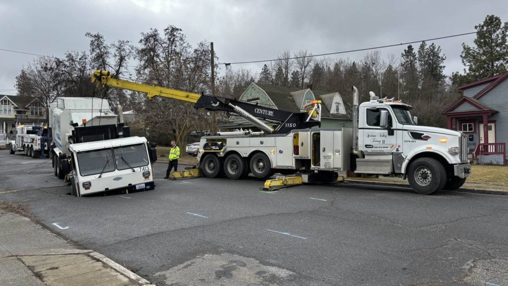 Garbage truck falls into sinkhole in Spokane - KIRO Seattle