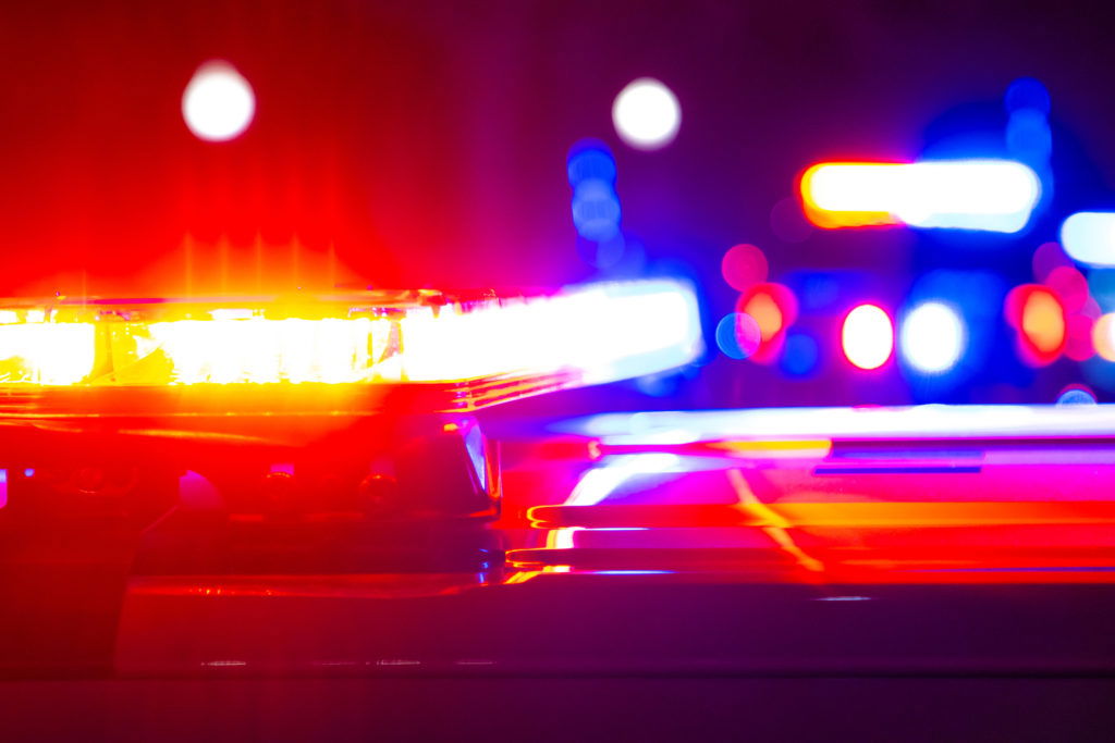 Red and blue flashing police lights at a crime scene.