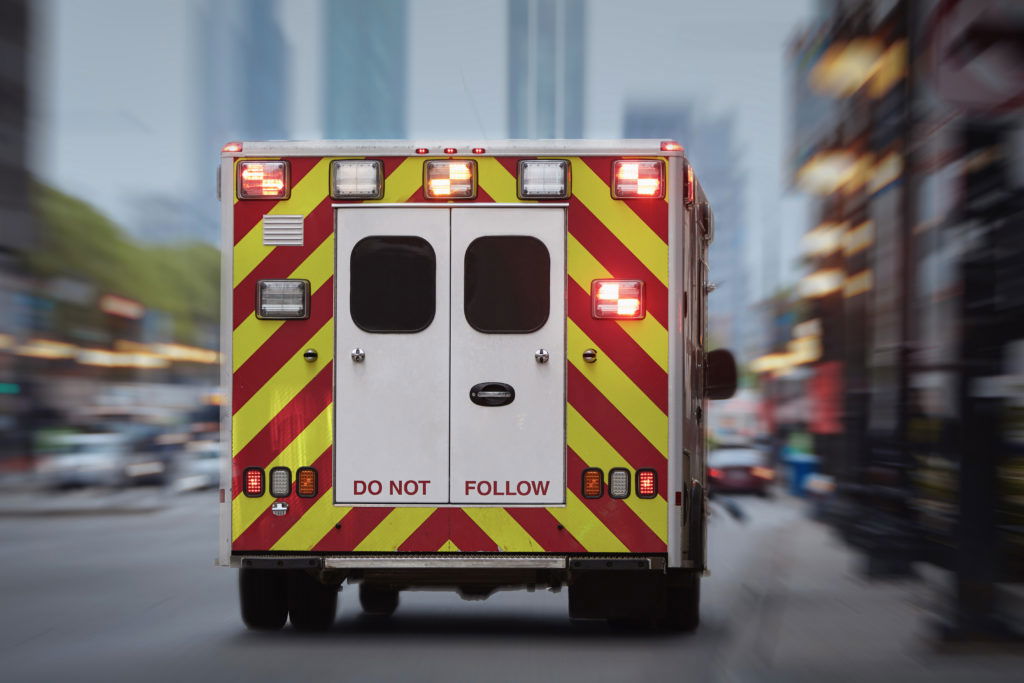 Ambulance car of emergency medical service on urban street. Themes rescue, urgency and health care.