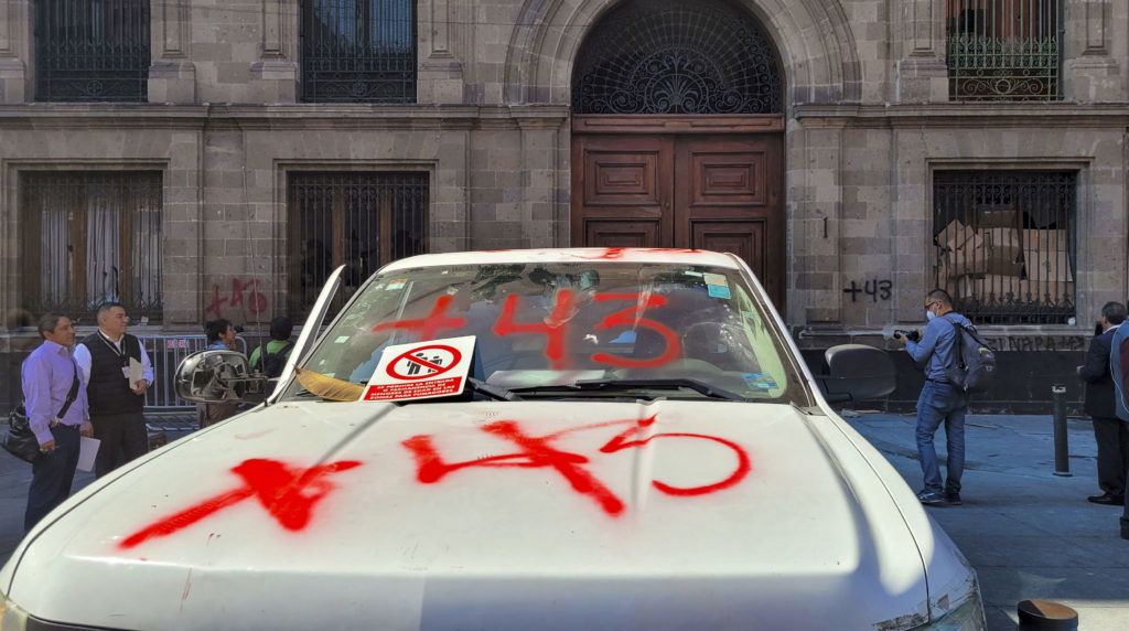 View of the destruction caused by demonstrators outside the presidential palace in Mexico City on March 6, 2024, during a protest over the disappearance of the 43 students of the Ayotzinapa teaching training school in 2014. Dozens of people demonstrating for the Ayotzinapa tragedy knocked down one of the doors of the Mexican National Palace with a pickup truck on Wednesday during the press conference of President Andres Manuel Lopez Obrador, who denounced a "provocation plan." (Photo by Ivan Castaneira / AFP) (Photo by IVAN CASTANEIRA/AFP via Getty Images)