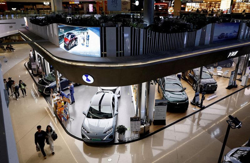 FILE PHOTO: Electric vehicles are displayed at a shopping mall in Beijing, China, Nov. 3, 2023. REUTERS/Tingshu Wang/File Photo