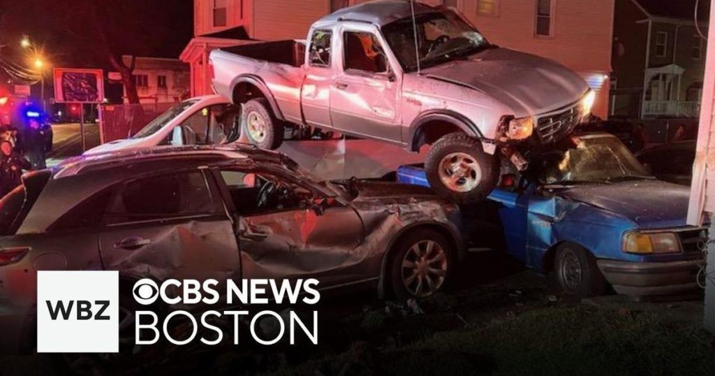 Driver flees crash after pickup truck lands on top of two parked cars in Brockton - CBS News