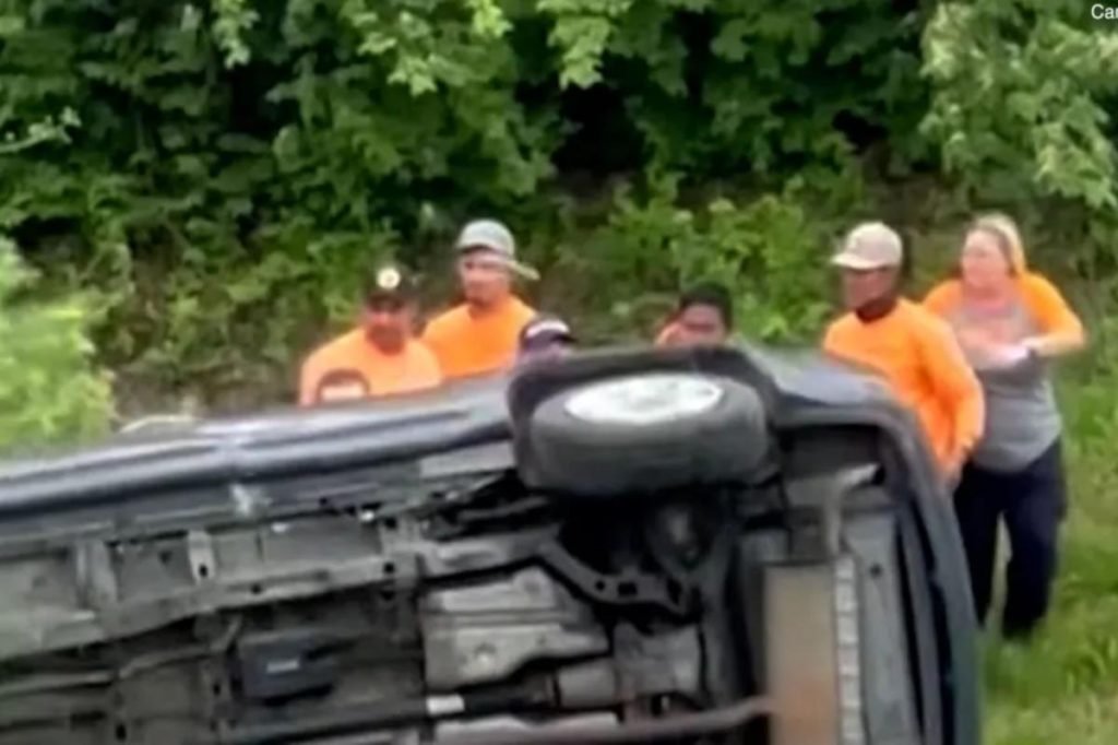 Good Samaritans band together to overturn a flipped car and rescue trapped woman - New York Post