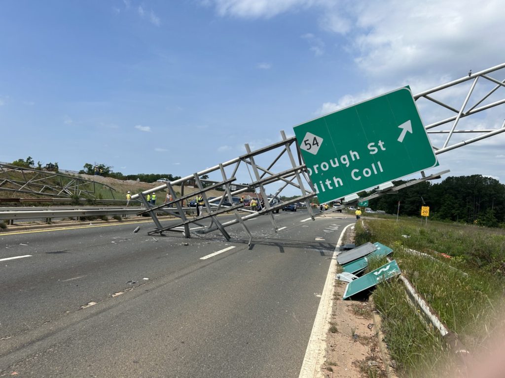 Truck plows into sign over I-440, causing major delays in Raleigh - CBS17.com