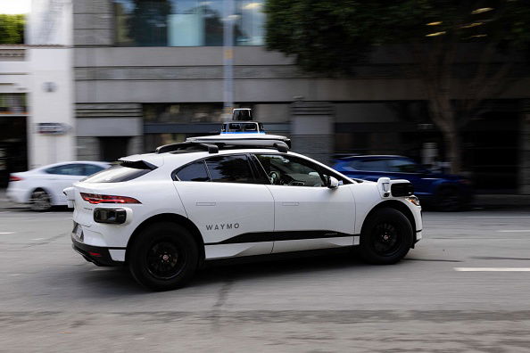 A Waymo autonomous vehicle turning onto Mission Street in San Francisco, on November 17, 2023. (Photo by Jason Henry / AFP) (Photo by JASON HENRY/AFP via Getty Images)