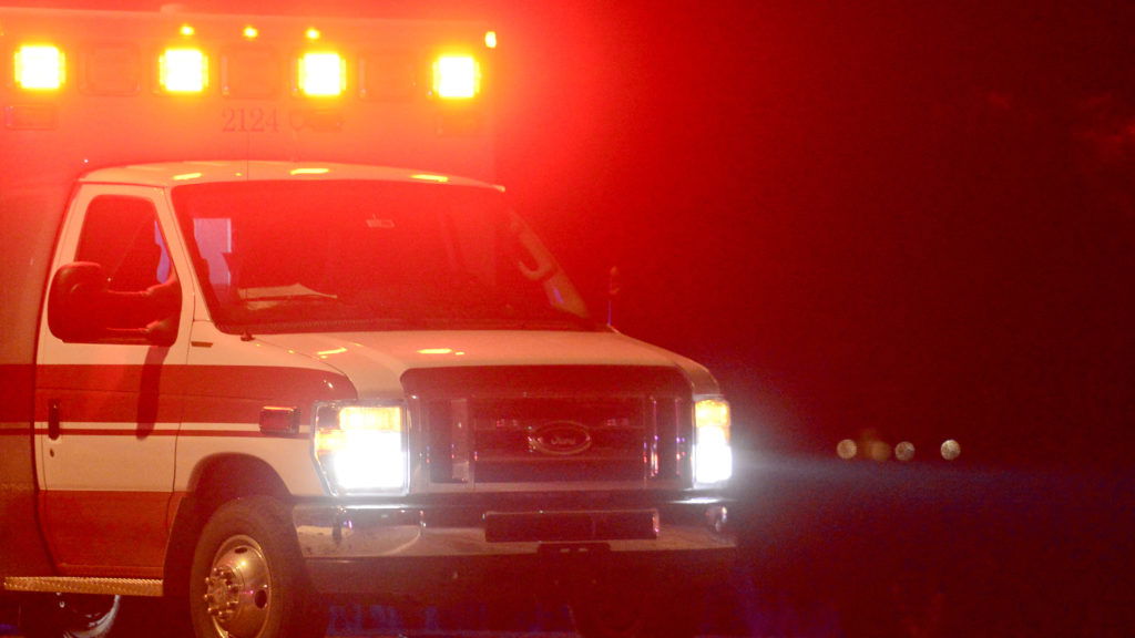 The lights of an ambulance illuminate a Longmont Police Officer as the Colorado State Patrol investigates a fatal crash involving two vehicles near Francis Street and Colo. 66  on Wednesday.(Photo by Matt Jonas/Digital First Media/Boulder Daily Camera via Getty Images)