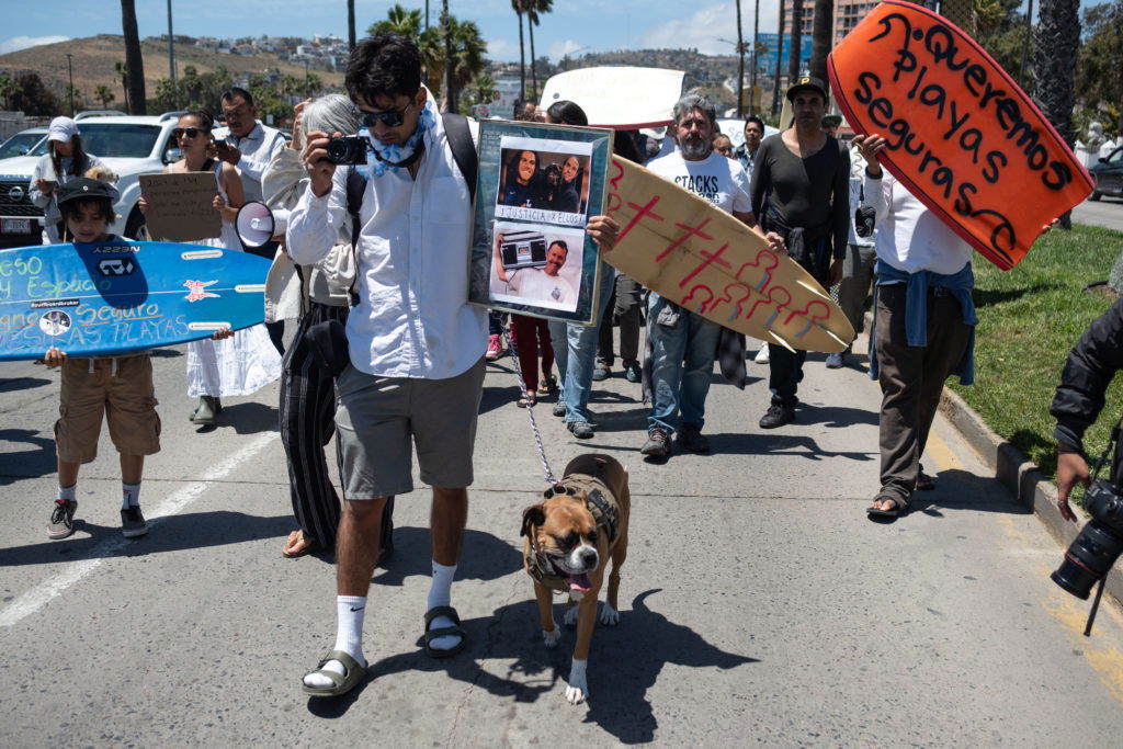 Members of the surfing community protest against insecurity after two Australians and an American surfers went missing last week during a surfing trip, in Ensenada, Baja California state, Mexico, on May 5, 2024. Three bodies believed to be those of two Australian brothers and an American who disappeared on a surfing trip in Mexico have bullet wounds to the head, authorities said Sunday. (Photo by Guillermo Arias / AFP) (Photo by GUILLERMO ARIAS/AFP via Getty Images)