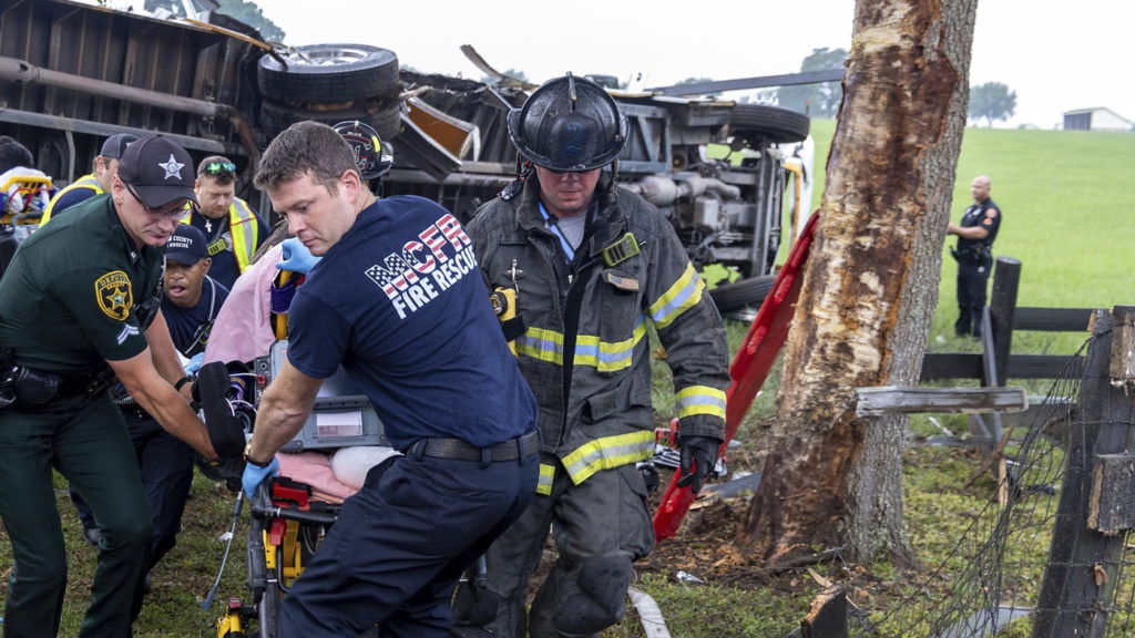 This photo provided by the Marion County Fire Rescue Dept. shows crews from Marion County Fire Rescue and the Marion County Sheriff’s Office assisting victims after a bus carrying farmworkers crashed and overturned early Tuesday, May 14, 2024 near Ocala, Fla. The Florida Highway Patrol says eight people were killed and nearly 40 others were injured. (Marion County Fire Rescue Dept. via AP)