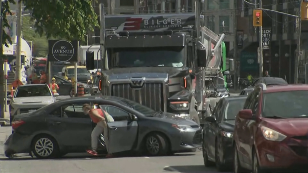 Video shows driver frantically getting out of car being pushed by truck on Avenue Road - CP24