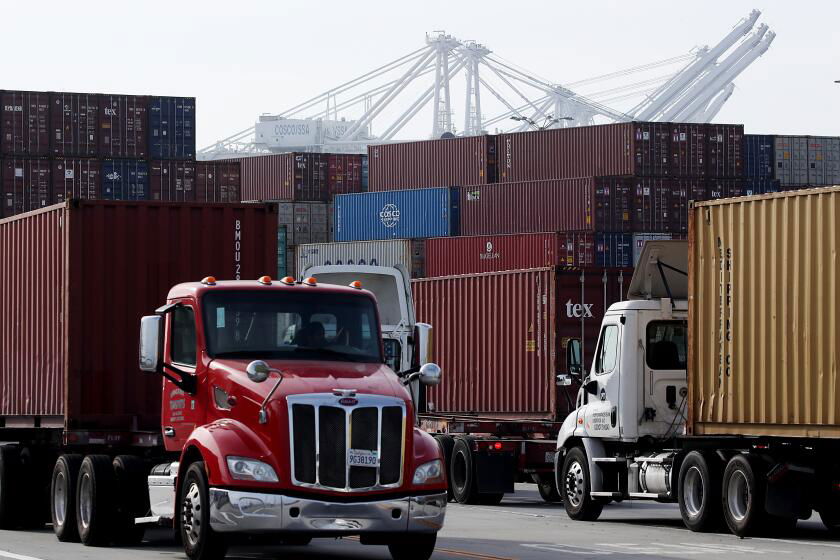 LONG BEACH, CALIF. - NOV. 18, 2021. Trucks haul cargo containers from a shipping terminal in the Port of Long Beach on Thursday, Nov. 18, 2021.  (Luis Sinco / Los Angeles Times)