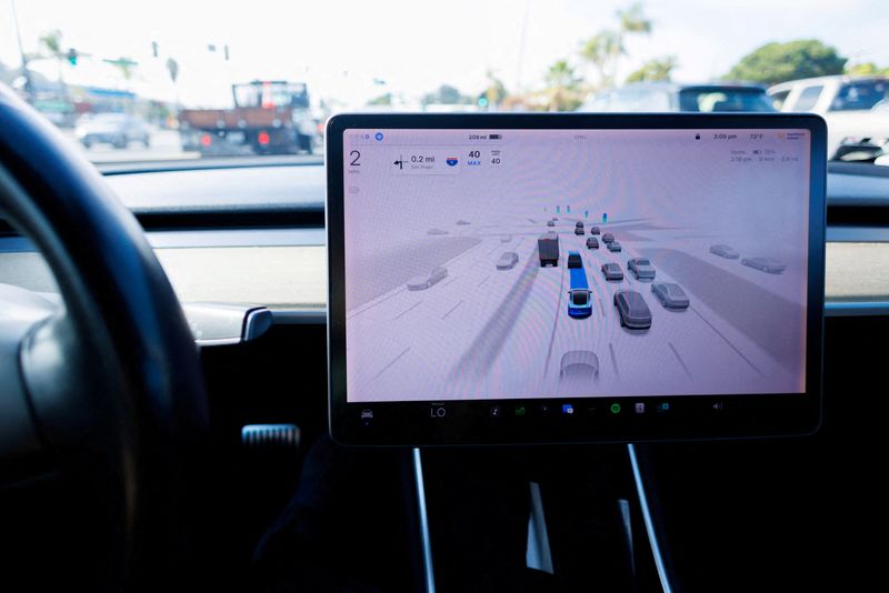 FILE PHOTO: A Tesla Model 3 vehicle drives using FSD (Full Self-Driving) in Encinitas, California, U.S., October 18, 2023.     REUTERS/Mike Blake/File Photo