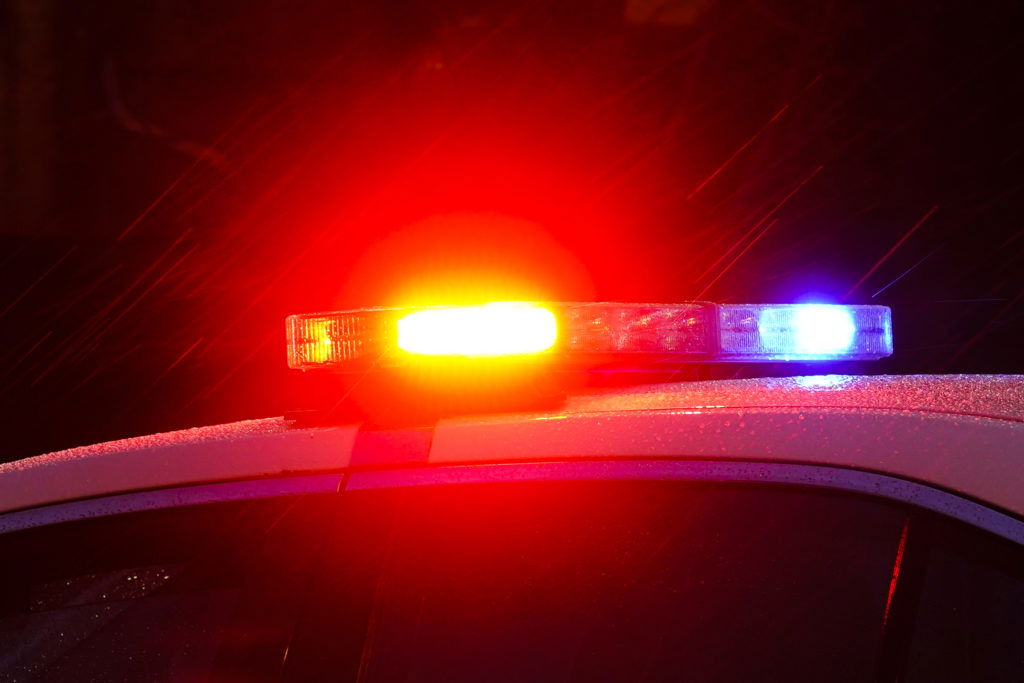 FILE - Shown is a Philadelphia police car with flashing lights in Philadelphia, Monday, Jan. 17, 2022. Police departments reported a year-over-year increase in sworn officers in 2023 for the first time since the COVID-19 pandemic began and since the 2020 police killing of George Floyd spurred nationwide protests and increased scrutiny of police, according to a survey released by the Police Executive Research Forum.  (AP Photo/Matt Rourke, File)