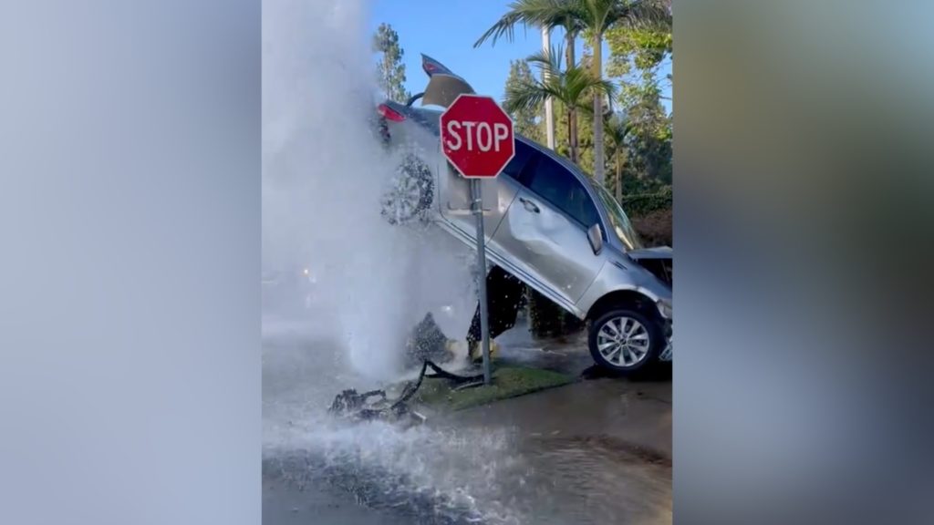 Crash in Orange County leaves car suspended by gushing water - KTLA Los Angeles