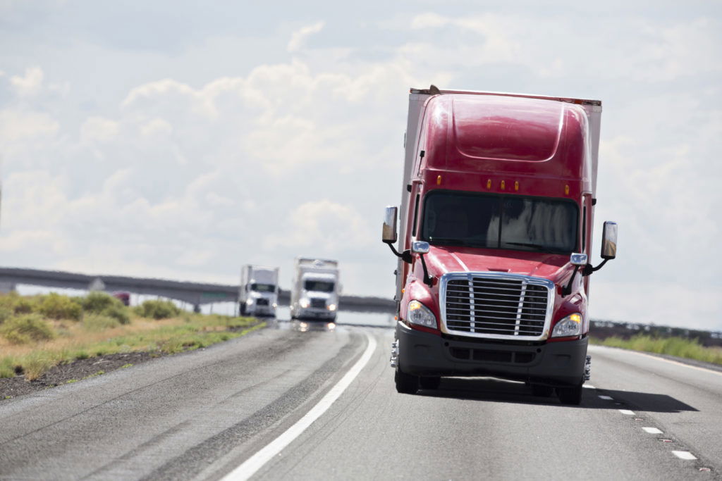 Semi trucks convoy on an interstate highwayPlease see similar images in my portfolio: