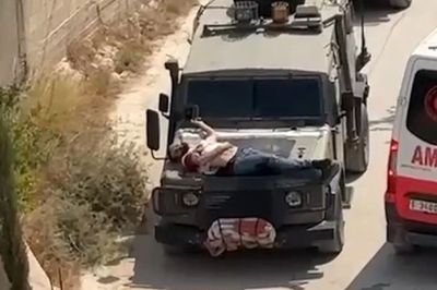 Outrage as Israeli troops strap injured Palestinian to bonnet of truck as 'human shield' - Irish Independent