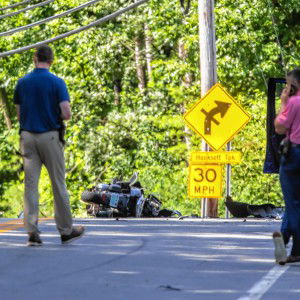 A motorcycle rests in the middle of Clinton Street near the Hooksett Turnpike intersection in Concord on Tuesday morning, July 16, 2024. The driver of the motorcycle was killed when it struck a blue pickup at right.