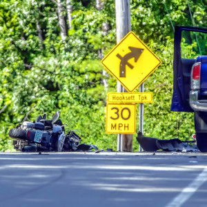 A motorcycle rests in the middle of Clinton Street near the Hooksett Turnpike intersection in Concord on Tuesday morning, July 16, 2024. The driver of the motorcycle was killed when it struck a blue pickup at right.