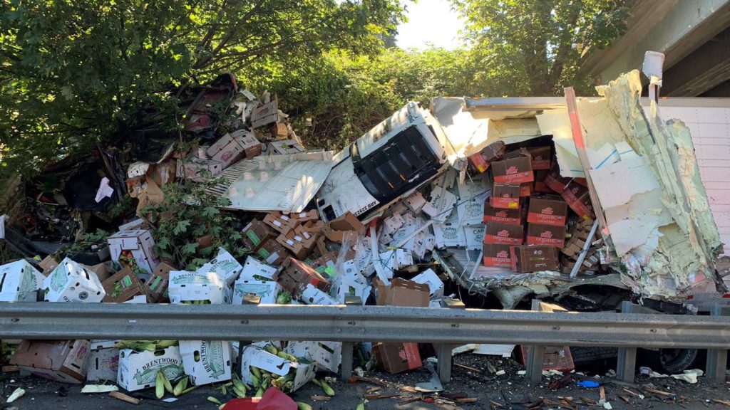 Semi-truck carrying vegetables takes out guard rail, ends under overpass in Tukwila - KIRO Seattle